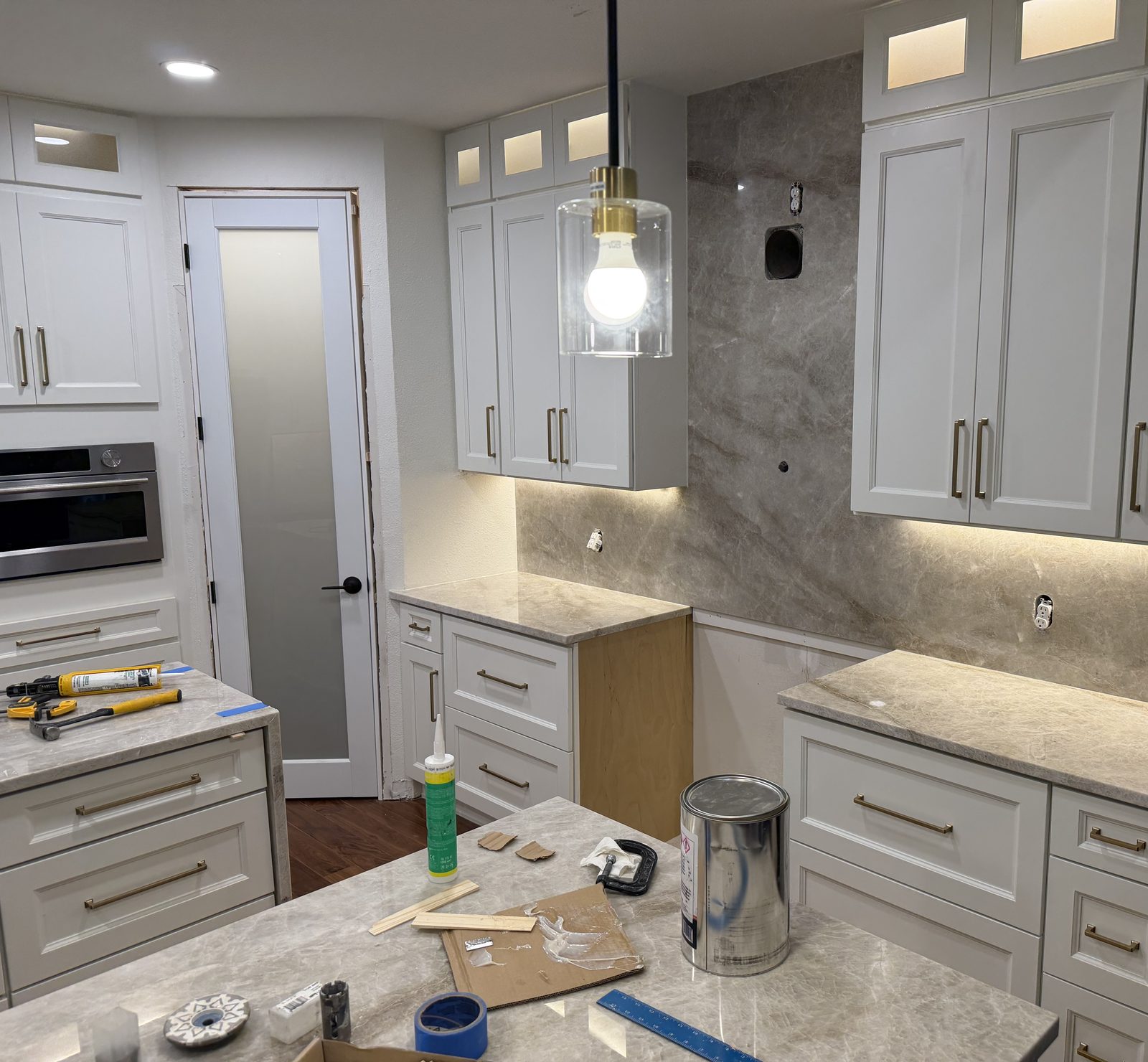 Kitchen remodel in progress in Murphy, TX with new cabinets, stone backsplash and lighting