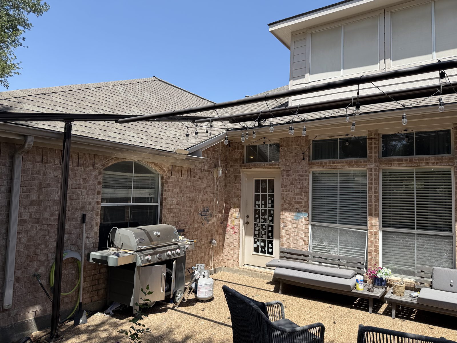 Existing patio seating and grill area before construction in Richardson, TX