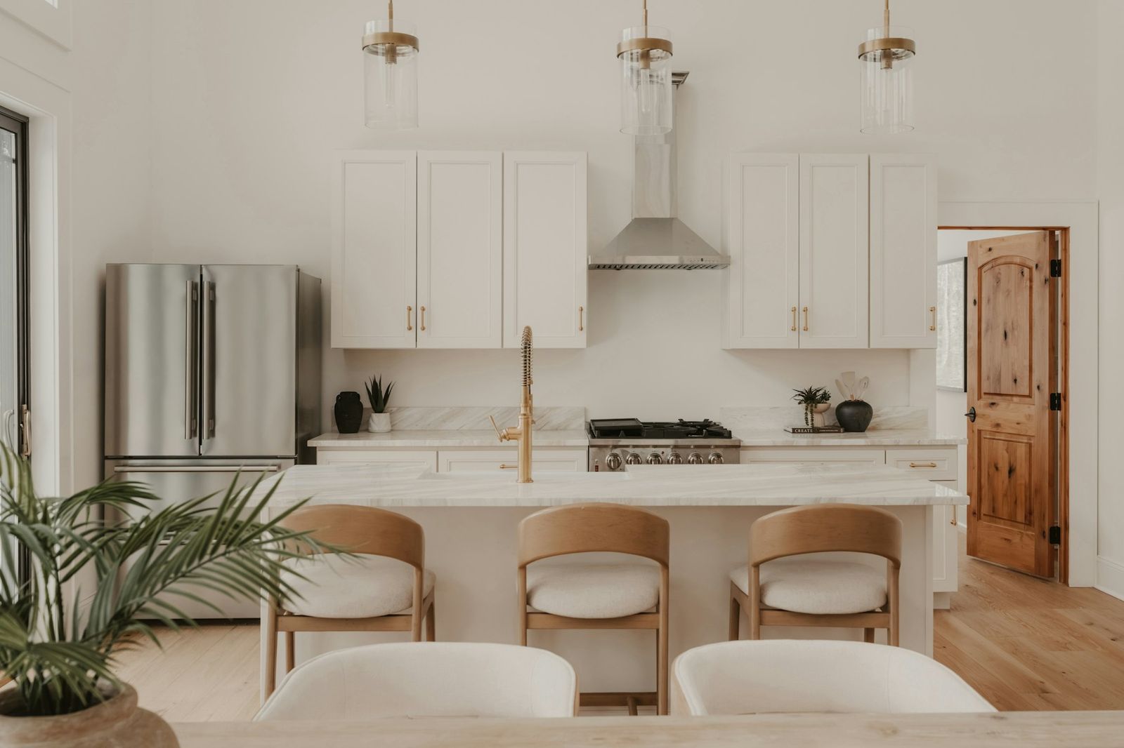 White shaker kitchen with island and brass pendant lights
