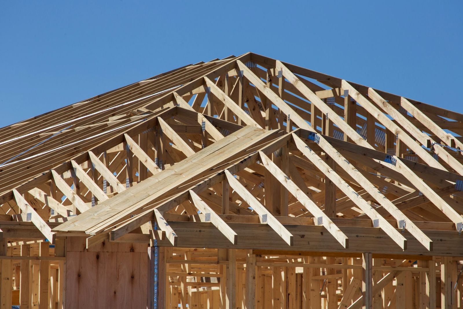 Wood roof trusses and wall framing on a new home under construction