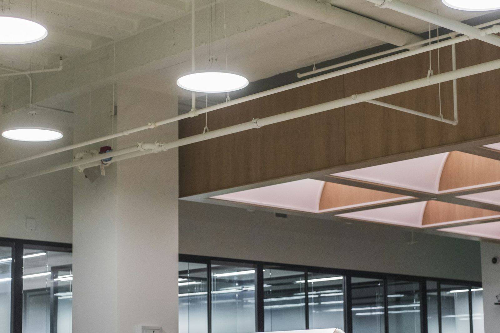 Open-plan commercial office interior with glass partitions